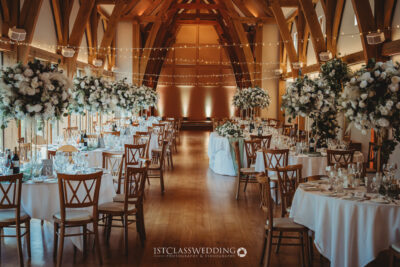 Elegant wedding venue with decorated tables and floral centerpieces.