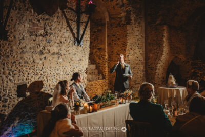 Wedding speech in historic venue with guests.