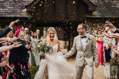 Bride and groom with confetti at wedding celebration at Huntsmill Farm