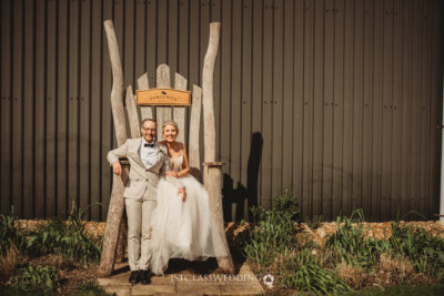 Couple posing on their wedding day outdoors at Huntsmill Farm.