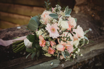 Elegant wedding bouquet with pink and white flowers.