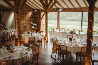 Rustic wedding venue interior with set tables.